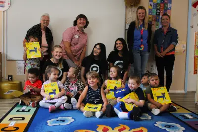 Volunteers foster literacy by reading to children and giving them books