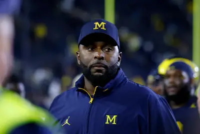 Fired Michigan football coach charged with home invasion and stalking