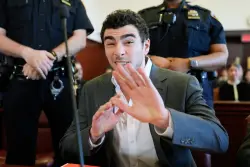 Luigi Mangione Beams and Gestures for the Cameras as Fan Group Says He’s Received 6,242 Love Letters and Counting and Raised $1.4 Million